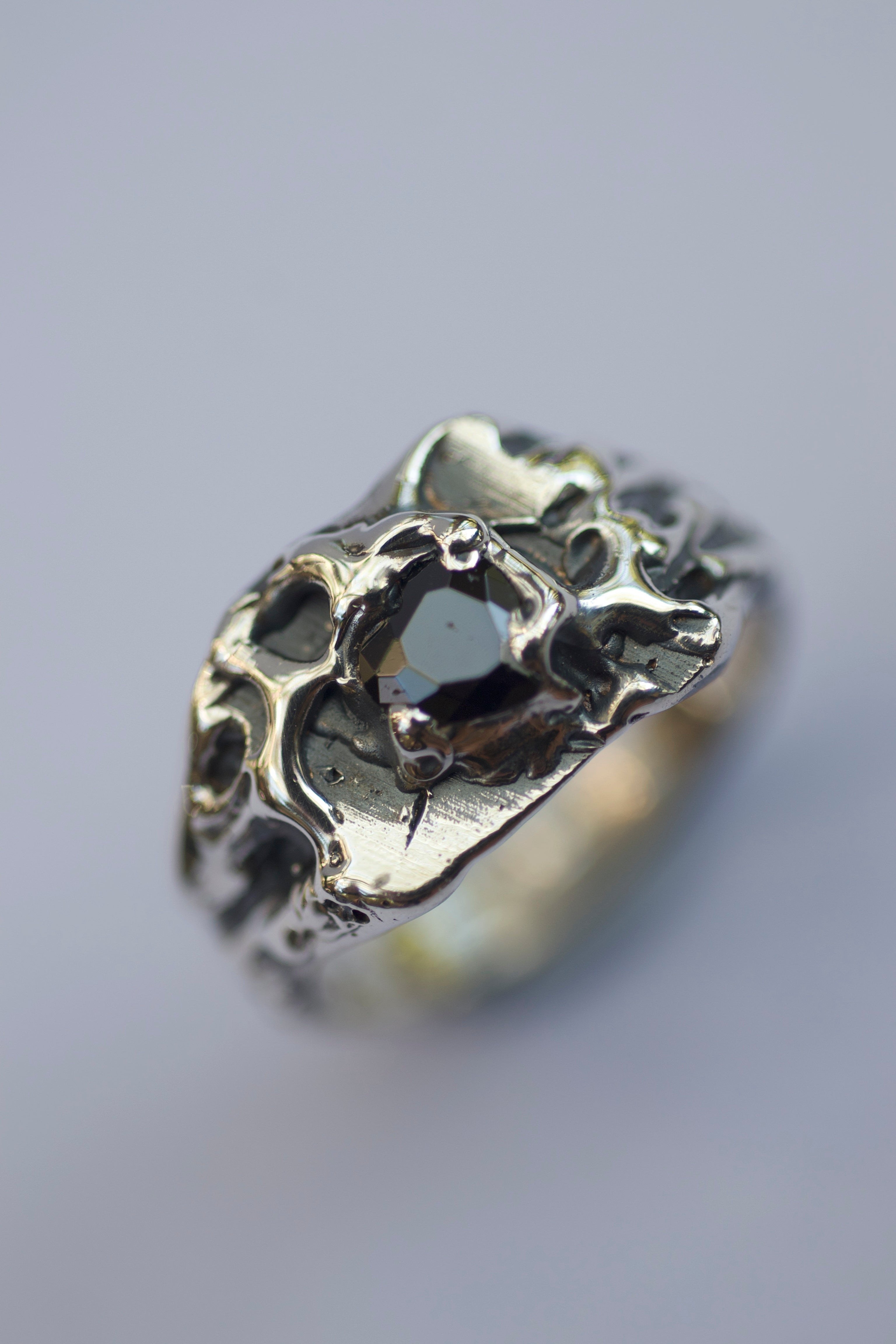 Hand-carved lost wax ring with organic textures, deep patina, and molten metal grooves, creating a dark, raw aesthetic.